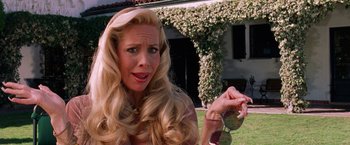 Movie still from “Legally Blonde” (2001), directed by Robert Luketic – A woman with long blonde hair holding a pair of sunglasses; Close Up shot, High angle