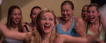 Movie still from “Legally Blonde” (2001), directed by Robert Luketic – A group of women standing next to each other in a room; Medium shot, High angle