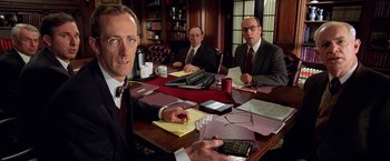 Movie still from “Legally Blonde” (2001), directed by Robert Luketic – A group of men sitting at a table with papers; Medium shot, Low angle