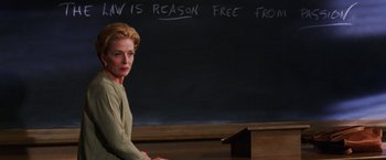 Movie still from “Legally Blonde” (2001), directed by Robert Luketic – A woman sitting in front of a chalkboard; Close Up shot, High angle