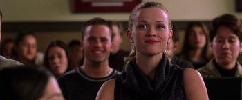 Movie still from “Legally Blonde” (2001), directed by Robert Luketic – A woman standing next to a man in front of a crowd; Close Up shot, Over the shoulder angle