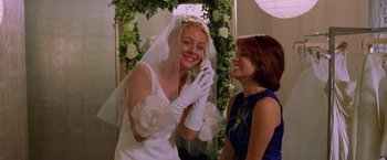Movie still from “Legally Blonde” (2001), directed by Robert Luketic – A bride and her mother are smiling for the camera; Medium shot, Over the shoulder angle