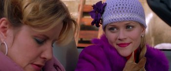 Movie still from “Legally Blonde” (2001), directed by Robert Luketic – A woman wearing a purple coat and a purple hat; Close Up shot, Over the shoulder angle