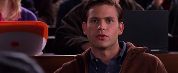 Movie still from “Legally Blonde” (2001), directed by Robert Luketic – A young man is sitting in front of a group of people; Close Up shot, Over the shoulder angle