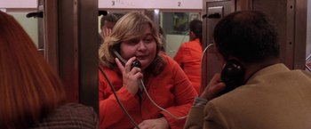 Movie still from “Legally Blonde” (2001), directed by Robert Luketic – A woman talking on a phone while sitting on a subway car; Close Up shot, Over the shoulder angle
