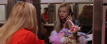 Movie still from “Legally Blonde” (2001), directed by Robert Luketic – A woman talking on a phone in front of a mirror; Medium shot, Over the shoulder angle