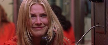 Movie still from “Legally Blonde” (2001), directed by Robert Luketic – A woman smiles while talking on a cell phone; Close Up shot, Over the shoulder angle