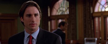 Movie still from “Legally Blonde” (2001), directed by Robert Luketic – A man in a suit and tie in a room; Close Up shot, Over the shoulder angle