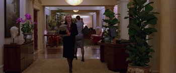 Movie still from “Legally Blonde” (2001), directed by Robert Luketic – A woman walking down a hall way holding a book; Wide shot, High angle