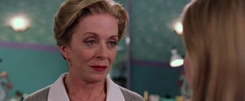 Movie still from “Legally Blonde” (2001), directed by Robert Luketic – An older woman with blonde hair wearing a white shirt; Close Up shot, Over the shoulder angle