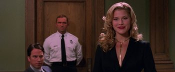 Movie still from “Legally Blonde” (2001), directed by Robert Luketic – A woman standing next to a man wearing a police uniform; Close Up shot, Over the shoulder angle