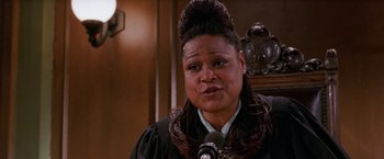 Movie still from “Legally Blonde” (2001), directed by Robert Luketic – A woman wearing a black robe and a black wig; Close Up shot, Low angle