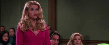 Movie still from “Legally Blonde” (2001), directed by Robert Luketic – A woman standing in front of two other people; Medium shot, Over the shoulder angle
