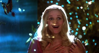 Movie still from “Legally Blonde 2: Red, White & Blonde” (2003), directed by Charles Herman-Wurmfeld – A woman with blonde long hair is smiling; Close Up shot, Low angle