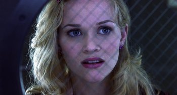 Movie still from “Legally Blonde 2: Red, White & Blonde” (2003), directed by Charles Herman-Wurmfeld – A woman's face with purple lighting behind it; Close Up shot, Low angle