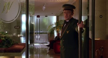 Movie still from “Legally Blonde 2: Red, White & Blonde” (2003), directed by Charles Herman-Wurmfeld – A man in a uniform standing next to a door; Medium shot, Low angle