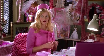Movie still from “Legally Blonde 2: Red, White & Blonde” (2003), directed by Charles Herman-Wurmfeld – A woman in a pink outfit sitting at a table; Medium shot, Over the shoulder angle