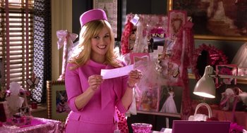Movie still from “Legally Blonde 2: Red, White & Blonde” (2003), directed by Charles Herman-Wurmfeld – A woman in a pink outfit holding a piece of paper; Medium shot, Over the shoulder angle