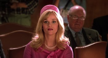 Movie still from “Legally Blonde 2: Red, White & Blonde” (2003), directed by Charles Herman-Wurmfeld – A woman wearing a pink dress and a pink hat; Close Up shot, Low angle