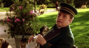 Movie still from “Legally Blonde 2: Red, White & Blonde” (2003), directed by Charles Herman-Wurmfeld – An old man sitting in a park holding a book; Medium shot, Over the shoulder angle