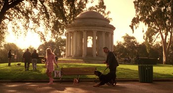 Movie still from “Legally Blonde 2: Red, White & Blonde” (2003), directed by Charles Herman-Wurmfeld – A man and a woman walking a dog on a leash; Wide shot, Low angle