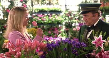 Movie still from “Legally Blonde 2: Red, White & Blonde” (2003), directed by Charles Herman-Wurmfeld – A woman holding a pink flower in her hand; Medium shot, Over the shoulder angle