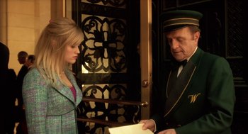 Movie still from “Legally Blonde 2: Red, White & Blonde” (2003), directed by Charles Herman-Wurmfeld – A man and a woman standing next to each other in front of a door; Medium shot, Low angle