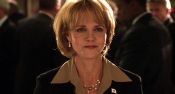 Movie still from “Legally Blonde 2: Red, White & Blonde” (2003), directed by Charles Herman-Wurmfeld – A person wearing a suit and a pearl necklace; Close Up shot, Low angle