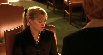 Movie still from “Legally Blonde 2: Red, White & Blonde” (2003), directed by Charles Herman-Wurmfeld – A woman sitting in front of a man in a suit; Close Up shot, High angle