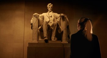 Movie still from “Legally Blonde 2: Red, White & Blonde” (2003), directed by Charles Herman-Wurmfeld – A man standing in front of a statue of abraham lincoln; Wide shot, Low angle