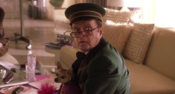 Movie still from “Legally Blonde 2: Red, White & Blonde” (2003), directed by Charles Herman-Wurmfeld – An older man holding a dog in his arms; Close Up shot, Low angle