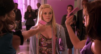 Movie still from “Legally Blonde 2: Red, White & Blonde” (2003), directed by Charles Herman-Wurmfeld – A young woman holding a cell phone up to her ear; Medium shot, Over the shoulder angle
