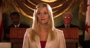 Movie still from “Legally Blonde 2: Red, White & Blonde” (2003), directed by Charles Herman-Wurmfeld – A woman with long blonde hair wearing a white jacket; Medium shot, Low angle