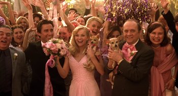 Movie still from “Legally Blonde 2: Red, White & Blonde” (2003), directed by Charles Herman-Wurmfeld – A group of people in a crowd holding flowers and a woman in a pink dress; Wide shot, Low angle