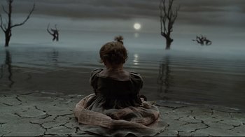 Movie still from “A Series of Unfortunate Events” (2004), directed by Brad Silberling – A little girl sitting in front of a body of water; Wide shot, High angle