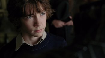 Movie still from “A Series of Unfortunate Events” (2004), directed by Brad Silberling – A boy with blue eyes stares into the distance; Close Up shot, Over the shoulder angle