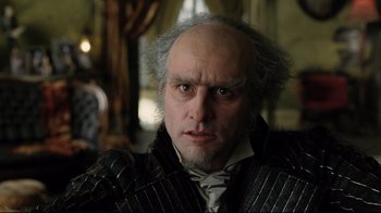 Movie still from “A Series of Unfortunate Events” (2004), directed by Brad Silberling – A person wearing a costume; Close Up shot, Low angle