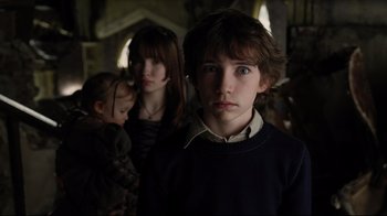 Movie still from “A Series of Unfortunate Events” (2004), directed by Brad Silberling – A boy and two other children in a room; Close Up shot, Low angle