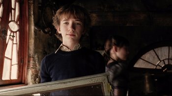 Movie still from “A Series of Unfortunate Events” (2004), directed by Brad Silberling – A young man standing in front of a mirror; Close Up shot, Over the shoulder angle