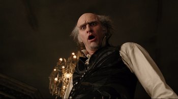 Movie still from “A Series of Unfortunate Events” (2004), directed by Brad Silberling – A man with a surprised look on his face; Close Up shot, Low angle