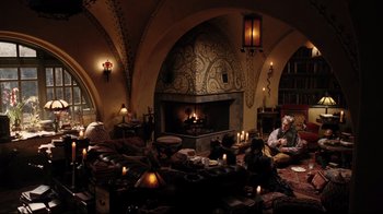 Movie still from “A Series of Unfortunate Events” (2004), directed by Brad Silberling – A group of people sitting around a living room; Wide shot, High angle