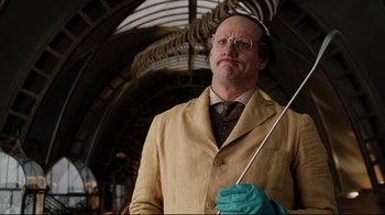 Movie still from “A Series of Unfortunate Events” (2004), directed by Brad Silberling – A man in a lab coat holding a metal rod; Medium shot, Low angle