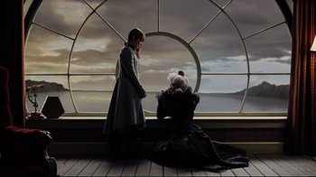 Movie still from “A Series of Unfortunate Events” (2004), directed by Brad Silberling – Two people standing in front of a window on a boat; Wide shot, High angle