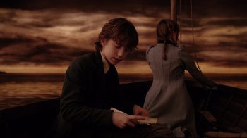 Movie still from “A Series of Unfortunate Events” (2004), directed by Brad Silberling – A boy and a girl are sitting on a bench; Medium shot, High angle