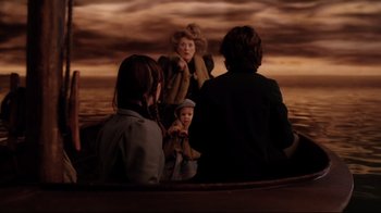 Movie still from “A Series of Unfortunate Events” (2004), directed by Brad Silberling – A group of people sitting in a boat on a body of water; Wide shot, Over the shoulder angle
