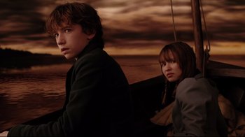 Movie still from “A Series of Unfortunate Events” (2004), directed by Brad Silberling – A boy and a girl sitting next to each other; Medium shot, Over the shoulder angle