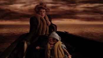 Movie still from “A Series of Unfortunate Events” (2004), directed by Brad Silberling – A woman sitting on a boat next to a young child; Medium shot, High angle