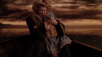 Movie still from “A Series of Unfortunate Events” (2004), directed by Brad Silberling – An older woman is holding a baby in her arms; Medium shot, High angle