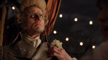 Movie still from “A Series of Unfortunate Events” (2004), directed by Brad Silberling – A person wearing a wig holding flowers; Close Up shot, Low angle