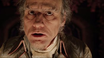Movie still from “A Series of Unfortunate Events” (2004), directed by Brad Silberling – An old man with a surprised look on his face; Close Up shot, Low angle